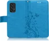 A blue flip case for a smartphone, with a floral and butterfly embossed pattern, is shown open. Produktbild-Vorschau