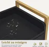 Close-up of a black surface with water droplets on it, with a gold handle in the background. Text and icons are present at the bottom. Produktbild-Vorschau