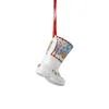A ceramic Christmas boot ornament hanging from a red ribbon. Produktbild-Vorschau