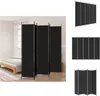 A black room divider is shown in a bedroom setting, with a bed and a rug visible. Produktbild-Vorschau