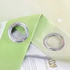 Close-up of green and yellow gradient curtains with star pattern and silver grommets. Produktbild-Vorschau