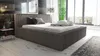 A modern bedroom with a large bed, large windows, and decorative elements. Produktbild-Vorschau