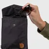 A hand is placing sunglasses into a black crossbody bag. Produktbild-Vorschau