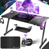A gaming desk setup with various accessories, illuminated by LED lights. Produktbild-Vorschau