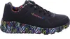 A single black Skechers sports shoe with a colorful heart pattern on the sole and inner lining, shown from the side against a white background. Voir les images du produit