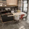 A modern kitchen and dining area with a dining table and chairs, a kitchen island, and appliances. Produktbild-Vorschau