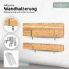 A marketing image showing two wooden planks mounted on a wall with metal brackets, along with accessories for mounting and ground anchoring. Produktbild-Vorschau