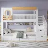 A white bunk bed with stairs and storage drawers, set against a light purple wall. Podgląd zdjęcia produktu