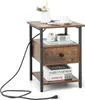 A small wooden side table with a drawer and shelves, decorated with a vase of flowers, a cup, and books. Produktbild-Vorschau