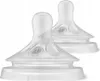 Two clear baby bottle nipples are shown against a white background. Voir les images du produit