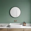 A modern bathroom sink area with a round mirror above it. Náhľad obrázku produktu