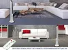 A split image showing a modern living room with a tower fan and a remote control in the bottom half, and a similar living room scene in the top half. Produktbild-Vorschau