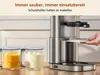 A person's hand is shown operating an ice cream maker, with two containers of ice cream or sorbet in the foreground. Podgląd zdjęcia produktu