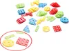 A collection of colorful building blocks with holes, scattered on a white background. Anteprima dell’immagine prodotto