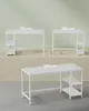 Three white desks of different sizes are displayed on a light green and tan background. Produktbild-Vorschau