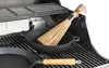 A close-up view of a grill with cooking utensils and cookware on the grates. Podgląd zdjęcia produktu
