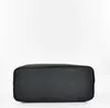 The bottom of a black handbag is shown against a white background. Produktbild-Vorschau
