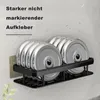 A wall-mounted shelf holding weight plates, with water droplets on the background suggesting a bathroom or shower environment. Produktbild-Vorschau