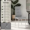 A gray upholstered dining chair with silver legs, presented with descriptive text and a close-up detail of the chair's button embellishment. Produktbild-Vorschau