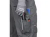 A close-up view of a person wearing work pants and a glove, with tools in the pocket. Náhled obrázku produktu