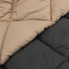A close-up view of a quilted blanket showing two different colored sections. Náhľad obrázku produktu