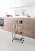 A metal storage trolley with items on it, placed in a kitchen setting. Produktbild-Vorschau