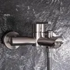 A close-up shot of a modern bathroom faucet mounted on a textured dark gray wall. Produktbild-Vorschau