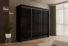 A modern bedroom with a large black sliding door wardrobe, a plant, and pendant lights. Produktbild-Vorschau