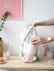 A person is putting a small pink object into a backpack. Anteprima dell’immagine prodotto