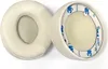 Two white ear pads for headphones are shown against a white background. Náhled obrázku produktu