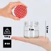 A hand holds a lid with red hearts above a glass jar held in another hand, with measurement indicators. Voir les images du produit