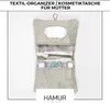 A hanging organizer bag with multiple compartments, filled with baby items. Produktbild-Vorschau