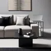 A laptop is placed on a side table next to a sofa, with a coffee table in front. Produktbild-Vorschau