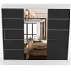 A wardrobe with mirrored doors reflecting a bedroom interior. Produktbild-Vorschau
