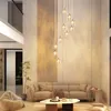 A modern living room with a large sectional sofa, a beanbag chair, and a multi-tiered chandelier. Podgląd zdjęcia produktu