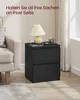 A black bedside table with a lamp, phone, and cup on top, next to a sofa. Produktbild-Vorschau