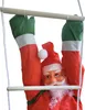 A close-up of a Santa Claus decoration hanging on a ladder. Produktbild-Vorschau