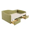 A light green upholstered daybed with two open drawers and an open storage compartment underneath. The bed frame is visible. Anteprima dell’immagine prodotto