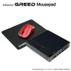 A red computer mouse sits on a black mousepad next to a small black computer. Text is visible at the top of the image. Produktbild-Vorschau