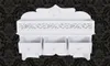 A white wall-mounted shelf with three drawers against a black damask patterned background. Náhled obrázku produktu