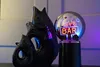 A black ceramic fish sculpture sits next to a glowing glass sphere with a neon "BAR" sign inside. Produktbild-Vorschau