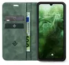 A green flip cover wallet case for a smartphone, open to reveal card slots and a banknote, with the smartphone screen displaying the time and date. Produktbild-Vorschau