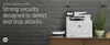 A white HP printer is placed on a wooden desk against a brick wall. Podgląd zdjęcia produktu