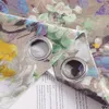 A close-up view of a floral patterned curtain with grommets, partially covering a book. Produktbild-Vorschau