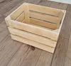A wooden crate is placed on a wooden floor. Produktbild-Vorschau