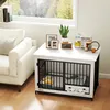 A dog crate is set up in a living room next to a sofa, with decorative items and pet supplies on top. Anteprima dell’immagine prodotto