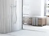 A modern bathroom shower with a sleek shower head and a wooden bench with a towel. Náhled obrázku produktu