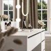 A vanity table with makeup and decor items, set against a window with curtains and greenery outside. Náhled obrázku produktu