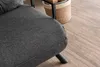 Close-up of a dark grey sofa with a woven basket and wooden accents in the background, on a wooden floor. Náhled obrázku produktu