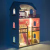 A lit-up dollhouse at night. Voir les images du produit
